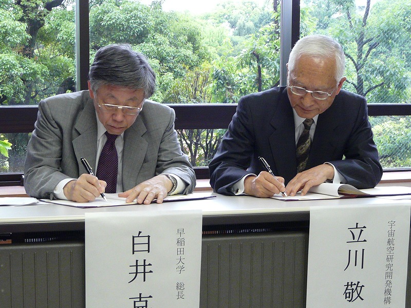 署名する早大の白井克彦総長(左)とJAXAの立川敬二理事長